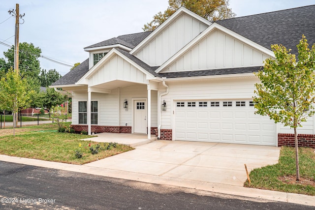 105 Wellston Pl, Louisville, KY 40207 - view of front facade featuring an attached garage, fence, driveway, board and batten siding, and roof with shingles