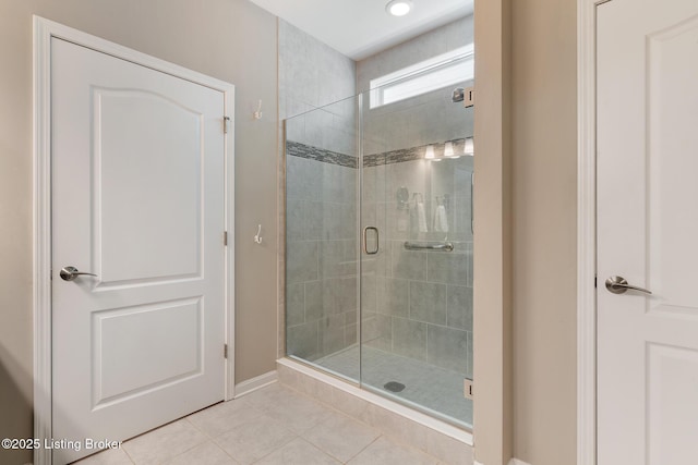 bathroom with baseboards, a stall shower, tile patterned floors, and recessed lighting