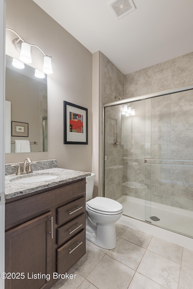 full bathroom featuring vanity, toilet, tile patterned floors, visible vents, and a stall shower
