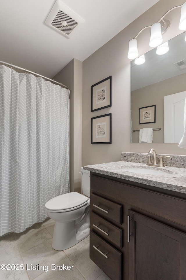 bathroom featuring visible vents, toilet, and vanity