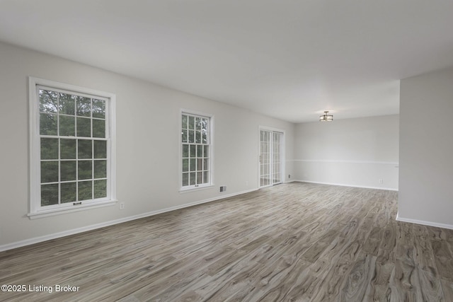 6505 Deep Creek Dr Unit 3, Prospect, KY 40059 - empty room with baseboards, visible vents, wood finished floors, and an inviting chandelier