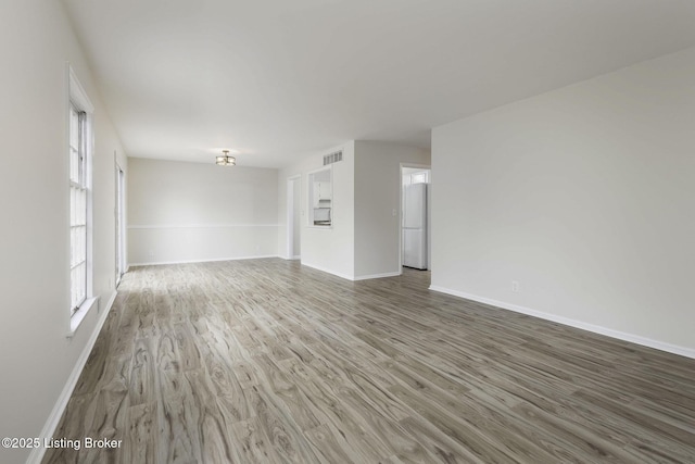 6505 Deep Creek Dr Unit 3, Prospect, KY 40059 - unfurnished living room featuring baseboards, visible vents, and wood finished floors