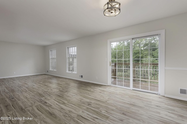 6505 Deep Creek Dr Unit 3, Prospect, KY 40059 - unfurnished living room with baseboards, wood finished floors, visible vents, and an inviting chandelier