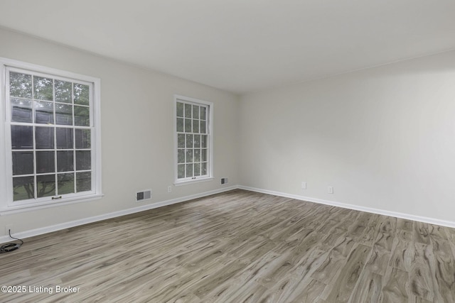 6505 Deep Creek Dr Unit 3, Prospect, KY 40059 - spare room featuring baseboards, visible vents, and wood finished floors