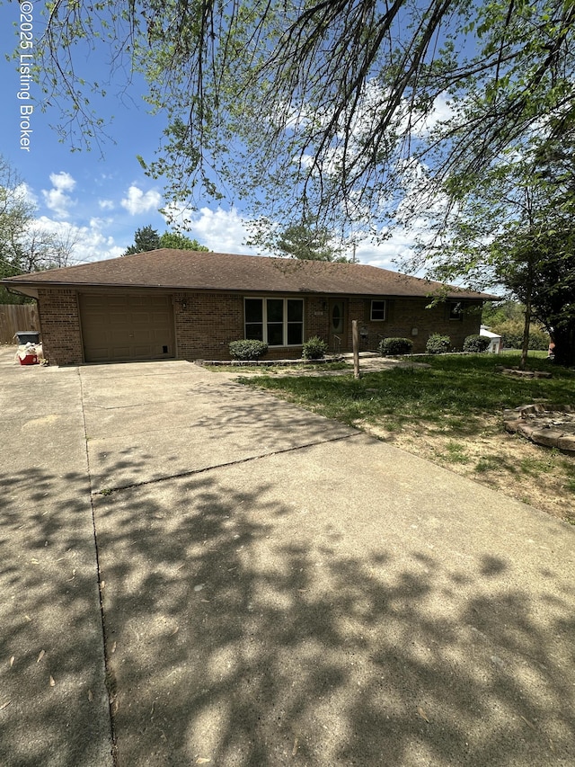 510 S Kentucky St, Irvington, KY 40146 - view of front facade featuring concrete driveway, brick siding, and a garage