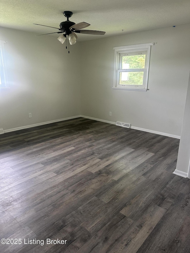 510 S Kentucky St, Irvington, KY 40146 - unfurnished room with visible vents, a ceiling fan, dark wood-type flooring, baseboards, and a textured ceiling
