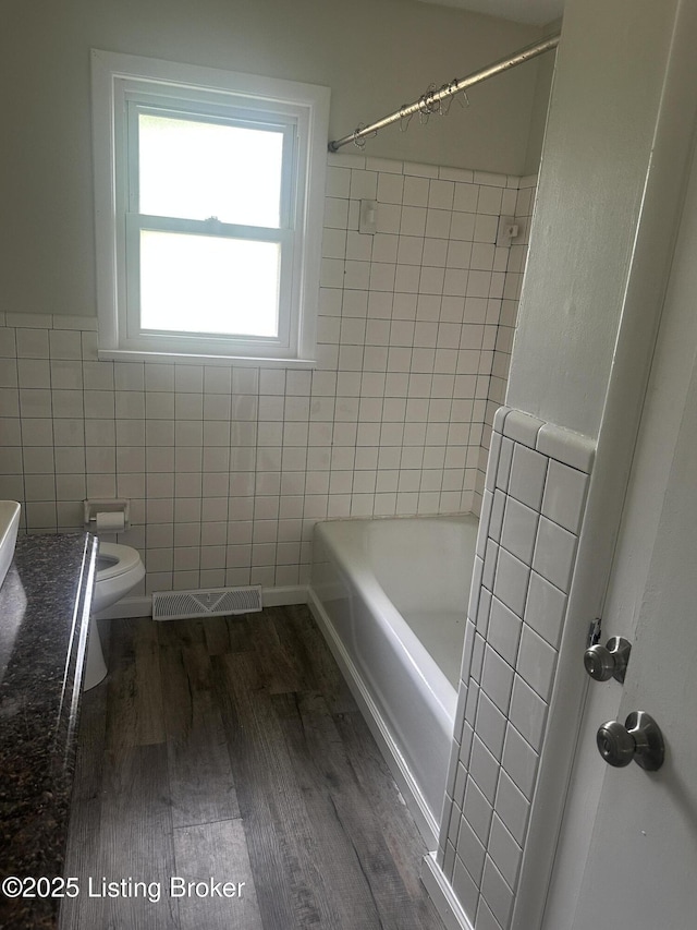 510 S Kentucky St, Irvington, KY 40146 - bathroom with wood finished floors, vanity, tile walls, toilet, and visible vents