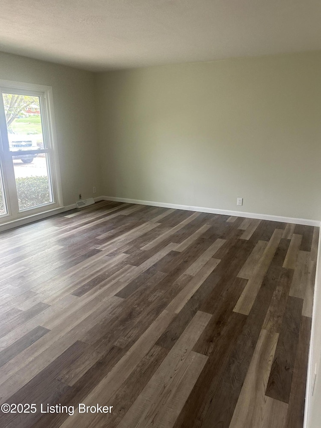 510 S Kentucky St, Irvington, KY 40146 - empty room featuring baseboards and dark wood-type flooring