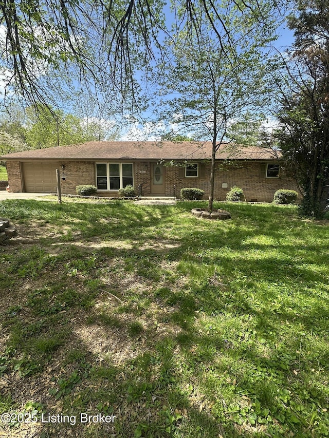 510 S Kentucky St, Irvington, KY 40146 - view of front of house featuring an attached garage, a front lawn, and brick siding