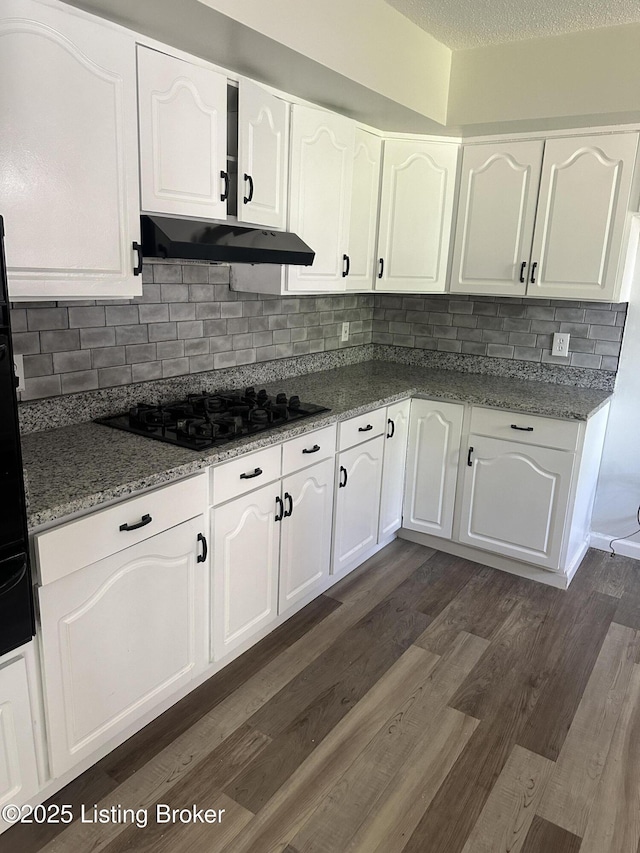 510 S Kentucky St, Irvington, KY 40146 - kitchen featuring dark wood finished floors, under cabinet range hood, white cabinetry, and black gas cooktop
