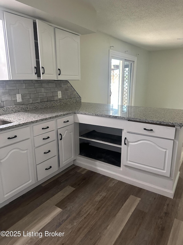 510 S Kentucky St, Irvington, KY 40146 - kitchen featuring a peninsula, white cabinetry, a textured ceiling, and dark wood-style floors