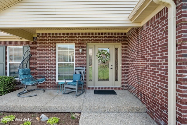 entrance to property featuring brick siding