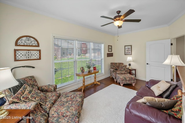 living area with plenty of natural light, wood finished floors, ornamental molding, and ceiling fan