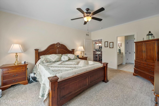 bedroom featuring light carpet, ensuite bathroom, baseboards, visible vents, and ceiling fan