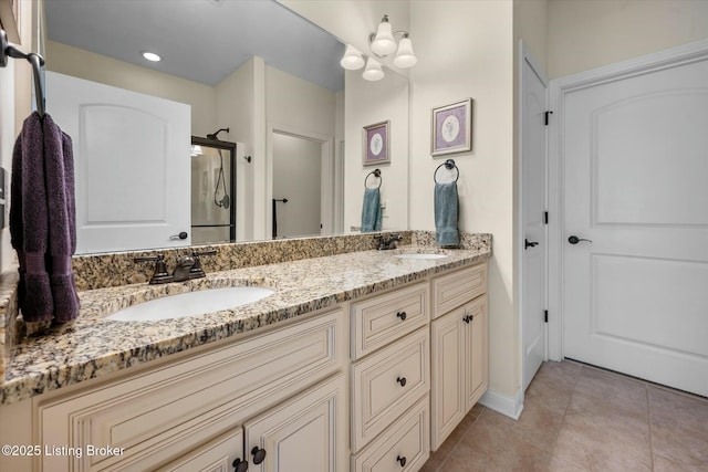 full bath featuring tile patterned floors, a sink, double vanity, and a stall shower