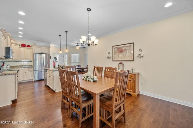 dining room with recessed lighting, ornamental molding, dark wood-style flooring, and ceiling fan with notable chandelier