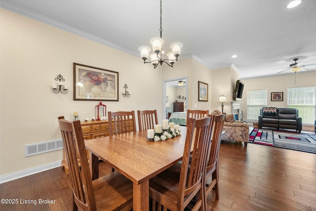 dining space featuring visible vents, ornamental molding, and ceiling fan with notable chandelier