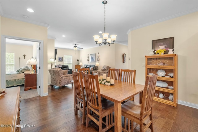 dining area featuring wood finished floors, a healthy amount of sunlight, and crown molding