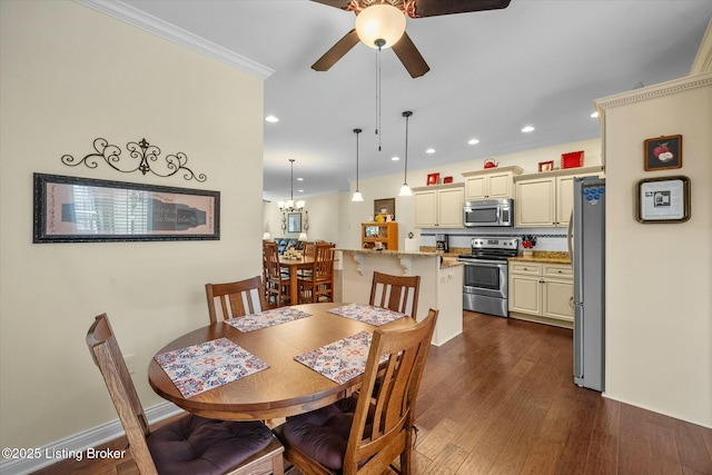 dining room with dark wood-type flooring, crown molding, recessed lighting, and ceiling fan with notable chandelier