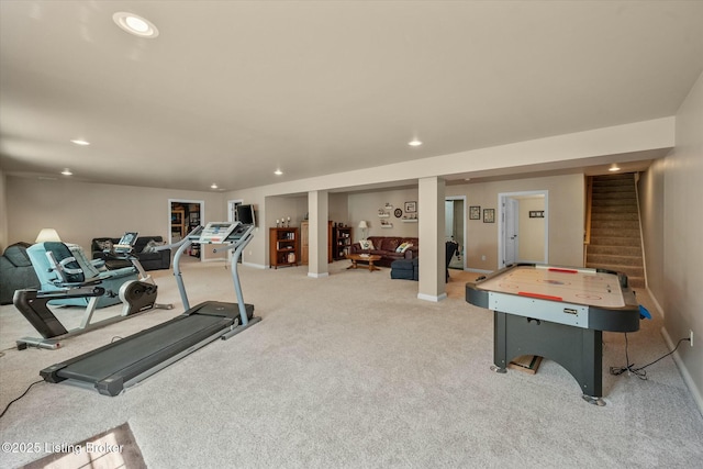 exercise area featuring baseboards, light carpet, and recessed lighting