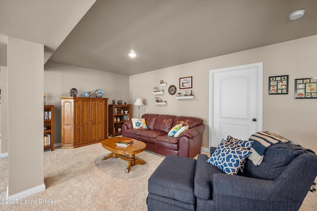 carpeted living room with baseboards