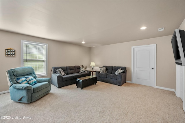 carpeted living area featuring visible vents, baseboards, and recessed lighting
