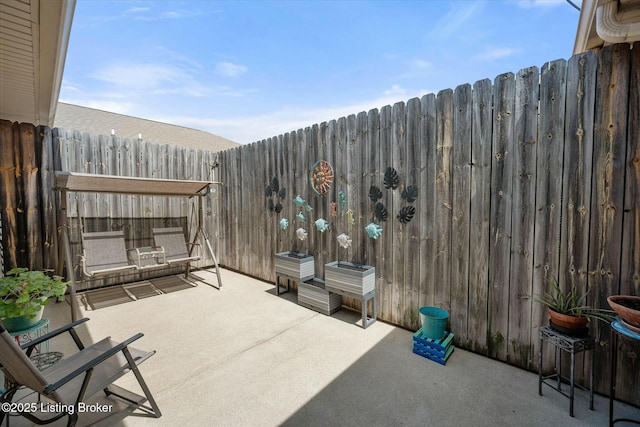 view of patio featuring fence