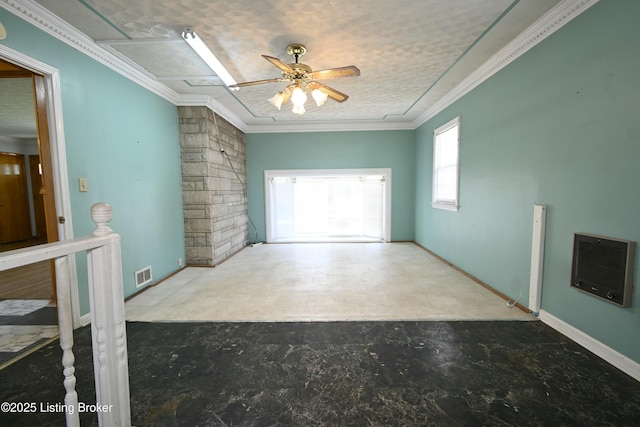 empty room featuring crown molding, ceiling fan, visible vents, and heating unit
