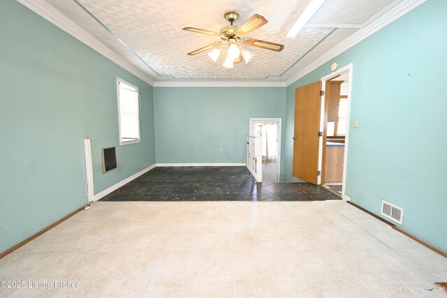 unfurnished room featuring crown molding, ceiling fan, visible vents, and baseboards