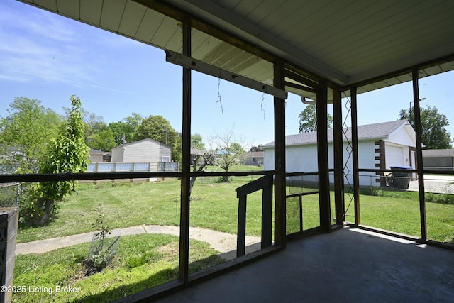 unfurnished sunroom featuring a residential view