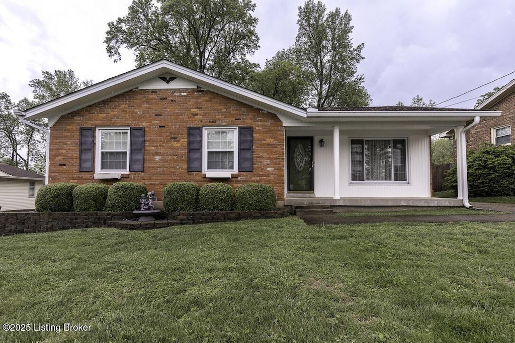 ranch-style house with a porch and a front lawn