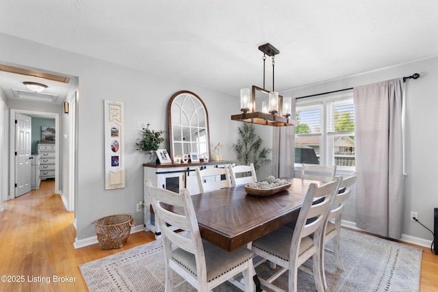 dining room with light wood-type flooring and baseboards