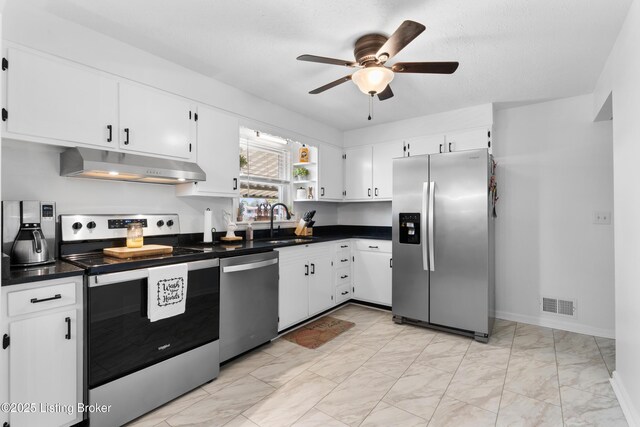 kitchen featuring a sink, visible vents, marble finish floor, under cabinet range hood, and appliances with stainless steel finishes