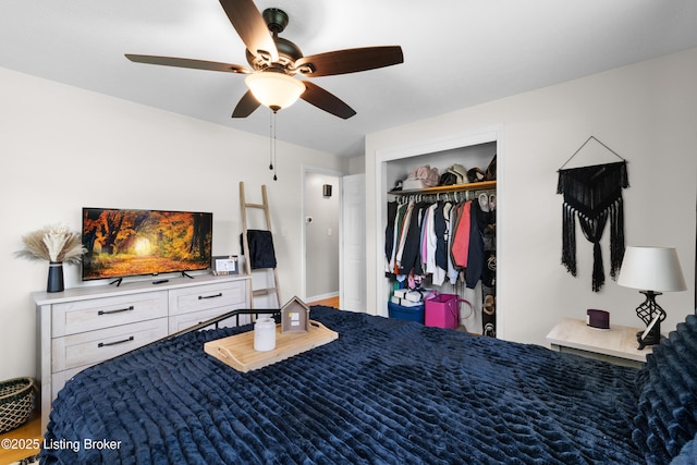 bedroom with a ceiling fan, wood finished floors, and a closet