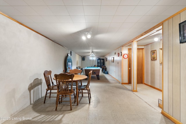 dining area with wooden walls and pool table