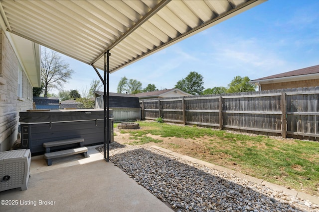view of yard featuring a fenced backyard, a hot tub, and a patio