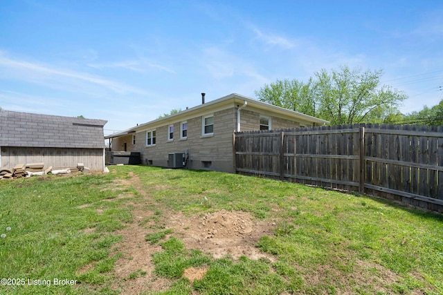 view of yard featuring fence and central AC unit