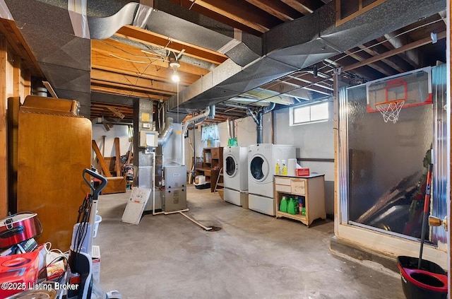 below grade area featuring washing machine and dryer and heating unit