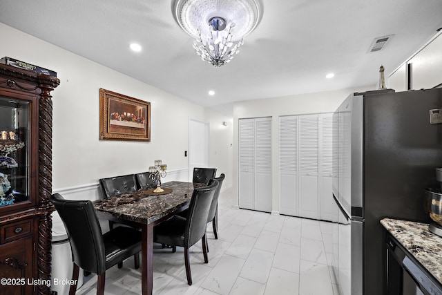 dining area with marble finish floor, a chandelier, visible vents, and recessed lighting
