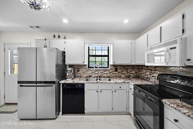 kitchen with a sink, black appliances, decorative backsplash, marble finish floor, and visible vents