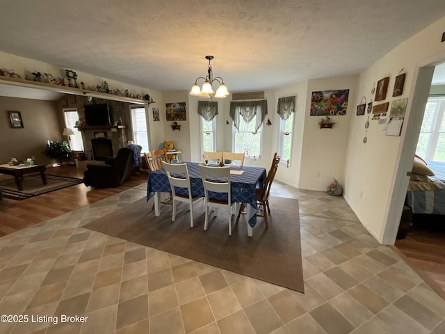 154 Gossom Ln, Milton, KY 40045 - dining space with a fireplace, a chandelier, and plenty of natural light