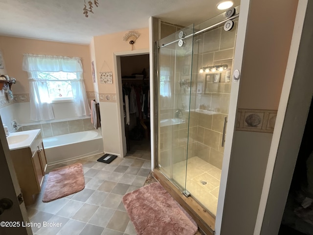 154 Gossom Ln, Milton, KY 40045 - full bath featuring a shower stall, a garden tub, a spacious closet, vanity, and tile patterned flooring