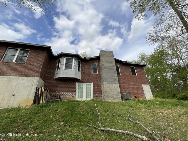 154 Gossom Ln, Milton, KY 40045 - rear view of house featuring brick siding, french doors, and central air condition unit