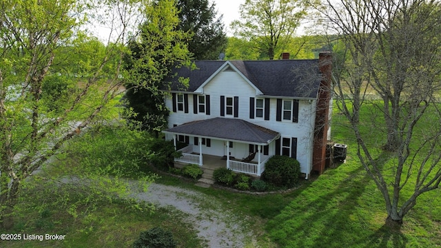 224 Spring Creek Ln, Milton, KY 40045 - colonial inspired home featuring a chimney, central AC unit, a porch, roof with shingles, and a front yard