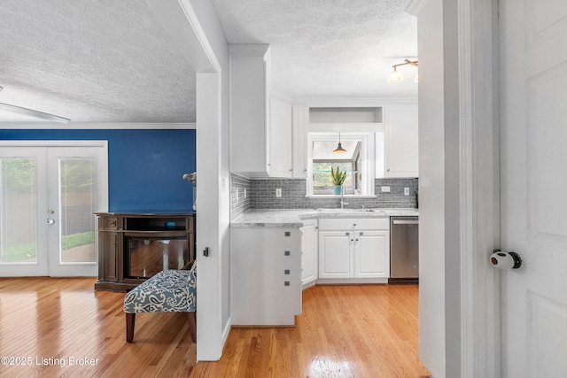 2807 Alice Ave, Louisville, KY 40220 - kitchen with dishwasher, a textured ceiling, light countertops, oven, and white cabinets