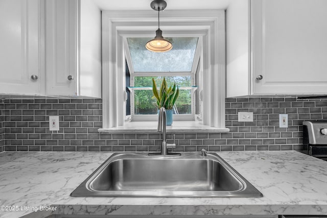 2807 Alice Ave, Louisville, KY 40220 - kitchen with a sink, white cabinets, hanging light fixtures, and tasteful backsplash