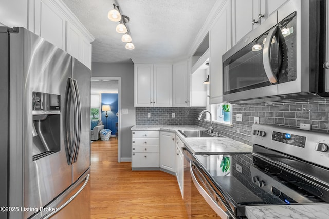 2807 Alice Ave, Louisville, KY 40220 - kitchen featuring stainless steel appliances, a sink, a textured ceiling, white cabinetry, and tasteful backsplash