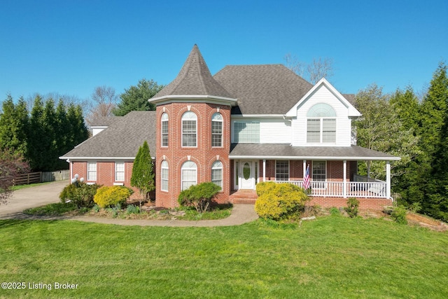 victorian house featuring covered porch, a front lawn, brick siding, and roof with shingles