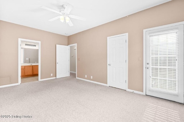 unfurnished bedroom with baseboards, light colored carpet, a ceiling fan, access to outside, and ensuite bath
