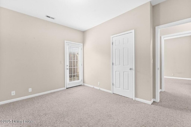 unfurnished bedroom featuring carpet, access to exterior, baseboards, and visible vents